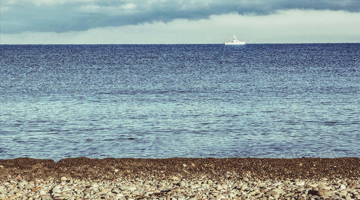 A ship on the Black Sea viewed from the beach in Georgia