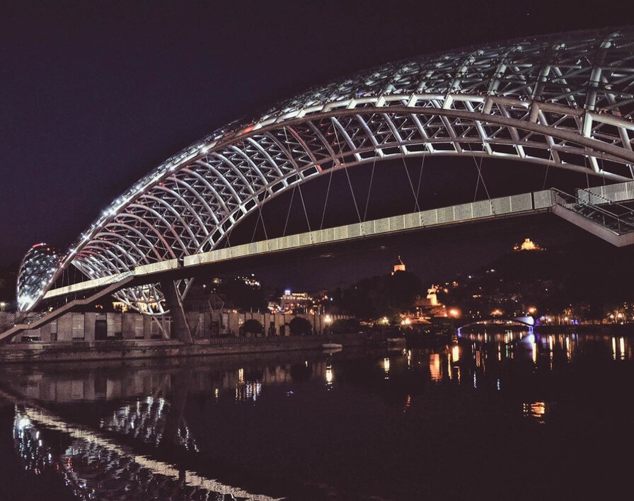 The modern Bridge of Peace in Georegia's capital Tbilisi by night